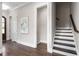 Inviting foyer with hardwood floors and staircase at 728 Peninsula Forest Pl, Cary, NC 27519