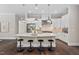 Bright kitchen with stainless appliances, a large island, and pendant lighting at 728 Peninsula Forest Pl, Cary, NC 27519