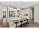Well-lit kitchen with stainless steel appliances, island, and white cabinetry at 728 Peninsula Forest Pl, Cary, NC 27519
