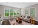 Inviting living room with natural light and comfortable seating at 728 Peninsula Forest Pl, Cary, NC 27519
