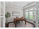 Bright office space with hardwood floors, tray ceiling, large windows, and a stylish desk at 728 Peninsula Forest Pl, Cary, NC 27519