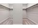 Spacious walk-in closet with shelving and carpeted floor, offering ample storage space at 728 Peninsula Forest Pl, Cary, NC 27519