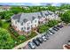 Aerial view of an apartment complex showing parking, landscaping, and architectural details, showcasing the entire layout at 734 Portstewart Dr, Cary, NC 27519