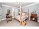 Serene bedroom featuring a four-poster bed with soft linens, complemented by neutral walls and carpet at 734 Portstewart Dr, Cary, NC 27519