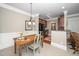 Dining space with a wooden table, unique chairs, and access to the kitchen, perfect for casual meals at 734 Portstewart Dr, Cary, NC 27519