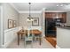 Charming dining area featuring a wooden table, stylish chairs, and a view of the adjacent kitchen space at 734 Portstewart Dr, Cary, NC 27519