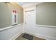 Entryway featuring a white door with a number, fire extinguisher box, and neutral walls, maintaining safety at 734 Portstewart Dr, Cary, NC 27519