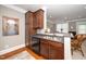 A kitchen featuring wood cabinetry, a tile backsplash, and stainless steel appliances, offering functionality and style at 734 Portstewart Dr, Cary, NC 27519