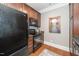 Modern kitchen featuring stainless steel appliances, wooden cabinets, and hardwood floors, enhancing a sleek design at 734 Portstewart Dr, Cary, NC 27519
