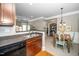 Cozy kitchen with stainless steel sink, granite countertop, and wood cabinets, flowing into the dining area at 734 Portstewart Dr, Cary, NC 27519