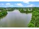 Scenic view of a lake surrounded by lush trees and homes in the distance at 734 Portstewart Dr, Cary, NC 27519