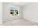 Bedroom with carpet flooring and a view of a neighboring house at 74 W Emily Gardens Dr, Selma, NC 27576