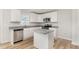 Bright kitchen features white cabinets, stainless steel appliances, and a granite countertop island at 74 W Emily Gardens Dr, Selma, NC 27576