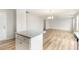 Modern kitchen with an island features white cabinets, granite countertops, and stainless steel appliances at 74 W Emily Gardens Dr, Selma, NC 27576