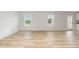 Bright living room boasts beautiful floors and large windows that allow natural light to flood the space at 74 W Emily Gardens Dr, Selma, NC 27576