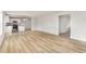 Open-concept living space shows the beautiful floors that seamlessly connect the living room and kitchen areas at 74 W Emily Gardens Dr, Selma, NC 27576