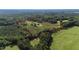 Large tract of land with an established home, long driveway and partial tree cover; property line is highlighted in red at 7620 Sam Hall Rd, Oxford, NC 27565