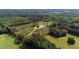 Gorgeous acreage with new construction, long driveway and surrounding wooded landscape; property line is highlighted in red at 7620 Sam Hall Rd, Oxford, NC 27565