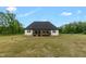 Exterior view of a house with a spacious backyard and an outdoor deck at 7620 Sam Hall Rd, Oxford, NC 27565