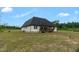 Exterior view of a house with a spacious backyard and an outdoor deck at 7620 Sam Hall Rd, Oxford, NC 27565