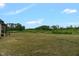 Exterior house view highlighting the expansive backyard and surrounding trees at 7620 Sam Hall Rd, Oxford, NC 27565