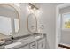 Bright bathroom featuring double sinks with granite counters, modern fixtures, and a shower at 7620 Sam Hall Rd, Oxford, NC 27565