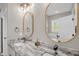 Bathroom featuring double sinks, granite countertop, and modern fixtures at 7620 Sam Hall Rd, Oxford, NC 27565