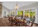 An elegant dining room features a large wooden table, decorative chandelier and sliding glass doors to the outdoors at 7620 Sam Hall Rd, Oxford, NC 27565