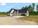 Beautiful exterior view of a two-story home featuring white siding, dark stone accents, and an attached two-car garage at 7620 Sam Hall Rd, Oxford, NC 27565