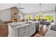 Kitchen island boasts granite countertops, gray cabinets, stainless steel appliances and brown flooring at 7620 Sam Hall Rd, Oxford, NC 27565