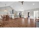 A spacious open-concept living area with modern kitchen, dining area, and elegant wood-look floors at 7620 Sam Hall Rd, Oxford, NC 27565