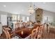 Expansive open living space features wood look tile flooring, kitchen with island, dining area, and stone fireplace at 7620 Sam Hall Rd, Oxford, NC 27565