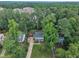 Aerial view of a charming home surrounded by lush greenery, showcasing its serene and private setting at 7917 Featherstone Dr, Raleigh, NC 27615