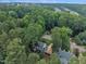 Aerial view of a charming home nestled among lush trees, showcasing its serene and private setting at 7917 Featherstone Dr, Raleigh, NC 27615