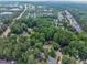 Scenic aerial shot showcases tree-lined streets and the homes nestled within a verdant, leafy suburb at 7917 Featherstone Dr, Raleigh, NC 27615