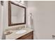 Bathroom boasts granite countertops, framed mirror, and a decorative stone arrangement by the sink at 7917 Featherstone Dr, Raleigh, NC 27615