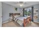 Cozy bedroom with wooden bed frame, ceiling fan, and natural light from the window at 7917 Featherstone Dr, Raleigh, NC 27615