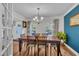 Bright dining room with hardwood floors, modern lighting, and neutral decor creating an inviting atmosphere at 7917 Featherstone Dr, Raleigh, NC 27615