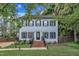 Charming two-story home with a well-maintained lawn, brick stairs, and a classic front door at 7917 Featherstone Dr, Raleigh, NC 27615