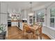 Updated kitchen with an adjacent dining area, stainless appliances, butcher block counters, and white cabinetry at 7917 Featherstone Dr, Raleigh, NC 27615