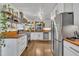 Spacious updated kitchen with stainless steel appliances, butcher block countertops, and decorative open shelving at 7917 Featherstone Dr, Raleigh, NC 27615