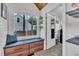 Mud room entry area with a built in bench, storage drawers, and plenty of light at 7917 Featherstone Dr, Raleigh, NC 27615