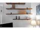 Wooden shelves display various decorative items, adding a touch of personal style to the room at 7917 Featherstone Dr, Raleigh, NC 27615
