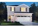 Two-story home featuring brick accents, a two-car garage, and gray siding at 808 Ottawa Dr, Garner, NC 27529
