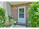 Inviting front door with white trim, brick surround, and decorative potted plants at 875 Martin Luther King Jr Blvd # 7, Chapel Hill, NC 27514
