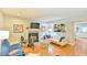 Cozy living room with fireplace, wood floors and pass-through to kitchen with breakfast bar at 875 Martin Luther King Jr Blvd # 7, Chapel Hill, NC 27514