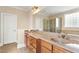 Bathroom showcasing double sink vanity with granite countertops and a large mirror at 10012 San Remo Pl, Wake Forest, NC 27587