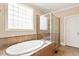 Bathroom showcasing large soaking tub and glass enclosed shower at 10012 San Remo Pl, Wake Forest, NC 27587