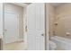 Neutral-toned bathroom featuring a shower-tub combination with white fixtures and tile floors at 10012 San Remo Pl, Wake Forest, NC 27587