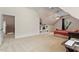 Large bonus room with plush carpet, built-in shelving, and a ceiling fan at 10012 San Remo Pl, Wake Forest, NC 27587